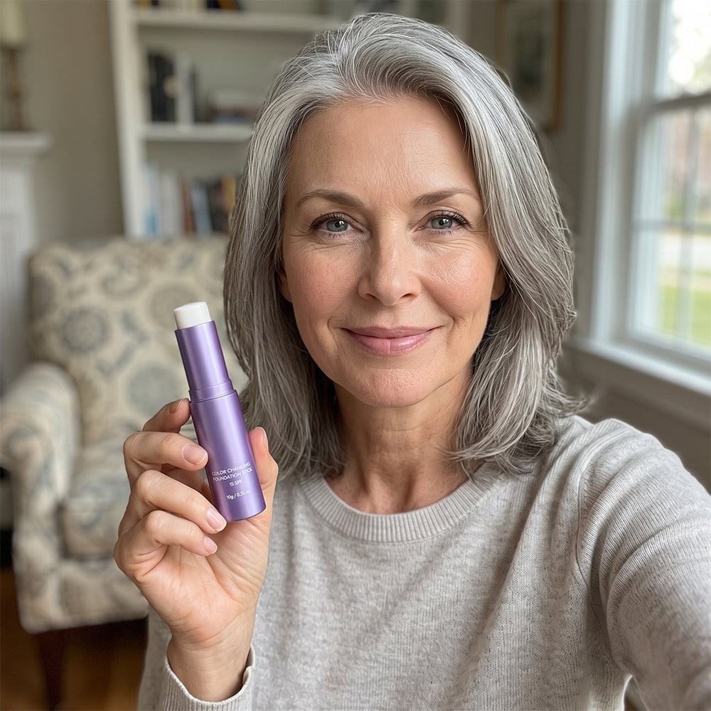 Woman holding the purple skin-tone adapting foundation stick