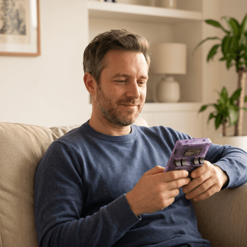 Person playing the Lookscene Pro 2.0 R36S retro gaming console at home